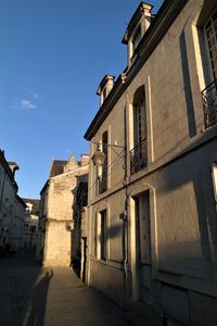 Low angle view of old building against blue sky