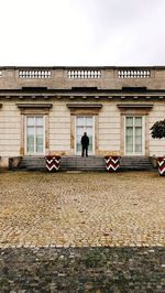 Man standing against building