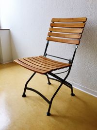 Empty chairs and table against wall at home