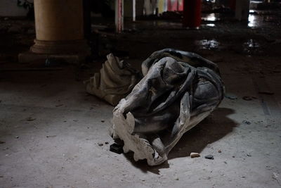 Close-up of abandoned shoe on floor in building