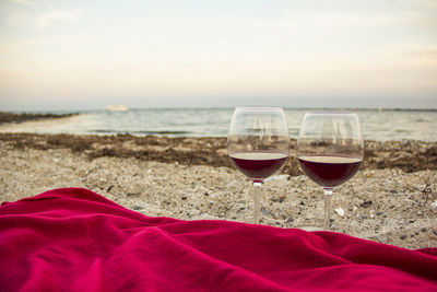 Red wine in wineglasses at beach during sunset