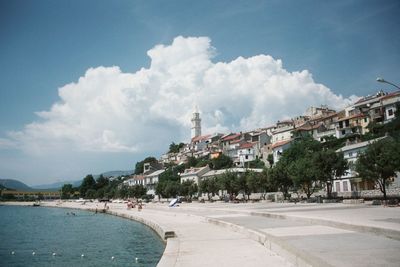 Panoramic view of city against cloudy sky