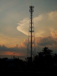 Low angle view of silhouette electricity pylon against sky during sunset