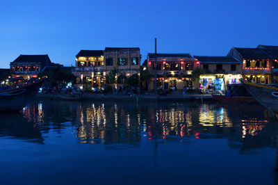 Reflection of illuminated buildings in water at night