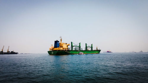 Ship in sea against clear sky