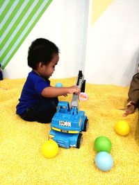 Boy playing with ball at home