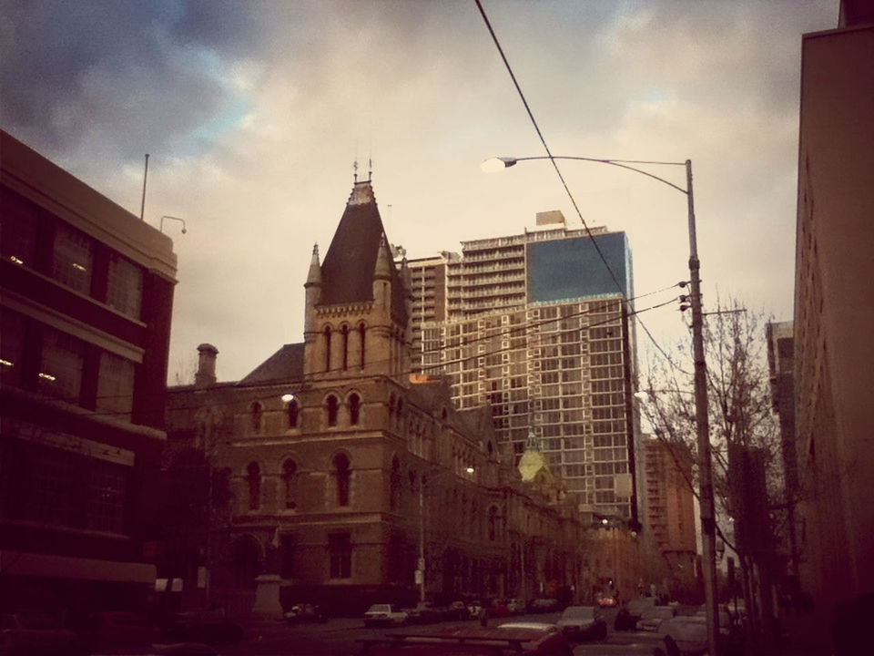 building exterior, architecture, built structure, sky, city, building, residential building, street, cloud - sky, low angle view, residential structure, cloud, city life, tall - high, tower, outdoors, street light, window, city street, car