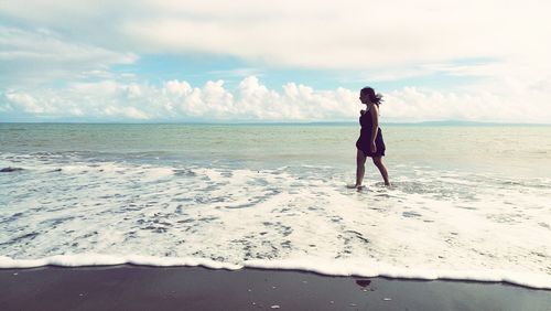 Full length of man on beach against sky