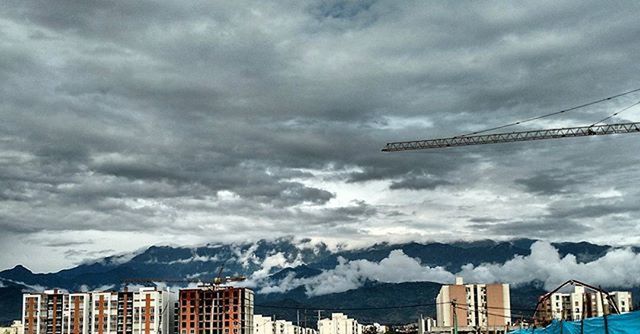 mountain, sky, mountain range, cloud - sky, architecture, built structure, building exterior, cloudy, weather, cloud, scenics, snowcapped mountain, winter, nature, snow, crane - construction machinery, day, beauty in nature, outdoors, city