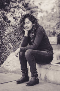 Portrait of young woman sitting outdoors