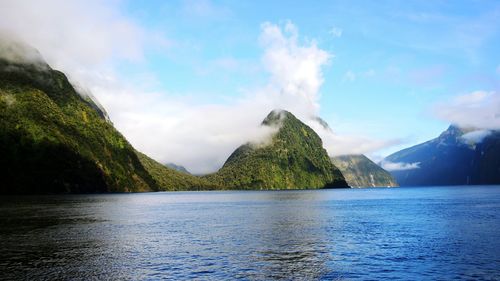 Scenic view of mitre peak and river against sky