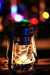 Close-up of illuminated lamp on table