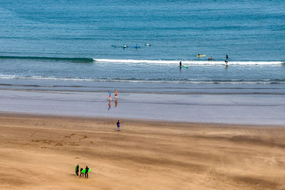 Surfers playing with atlantic waves, rabat, morocco.