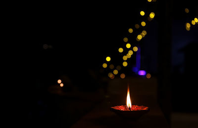 Close-up of lit candles in the dark