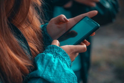 Close-up of woman using mobile phone