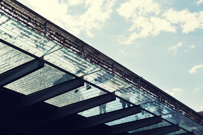 Low angle view of staircase by building against sky