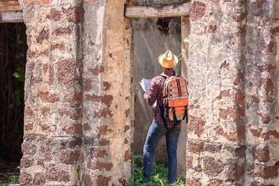 Rear view of hiker seen through doorway