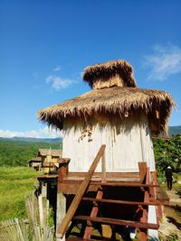 Built structure on field against sky