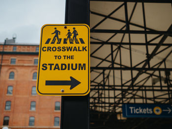 Close-up of road sign against built structure