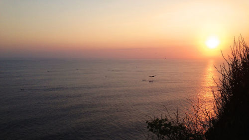 Scenic view of sea against orange sky