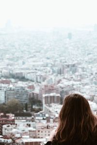 Rear view of woman looking at city buildings