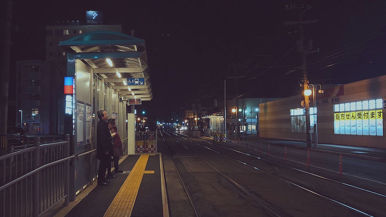 ILLUMINATED RAILROAD TRACKS AT NIGHT