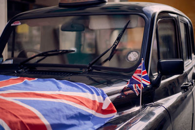 Close-up of car with union jack flags on it