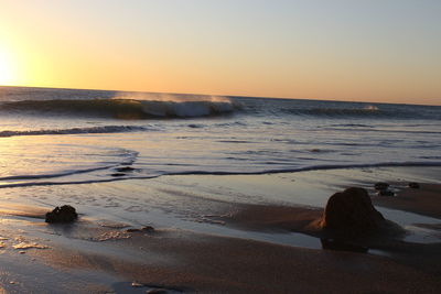 Scenic view of sea against clear sky during sunset