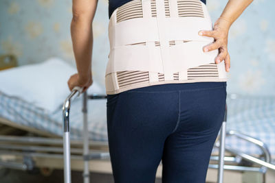 Midsection of woman wearing belt on lower back