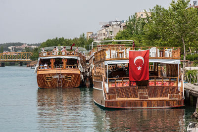 Boat moored on river against clear sky