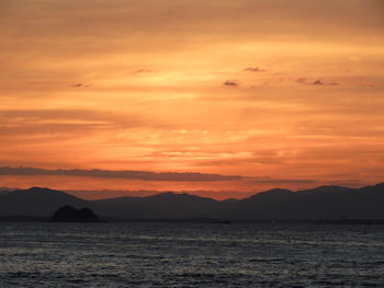 Scenic view of sea against romantic sky at sunset