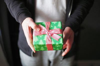 Midsection of woman holding small box