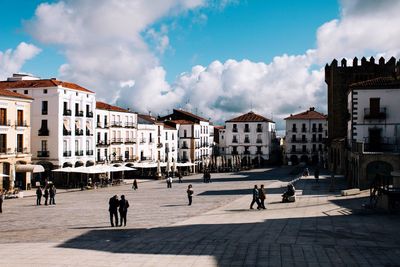Buildings in city against cloudy sky