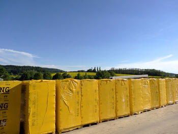 Scenic view of yellow wall against blue sky