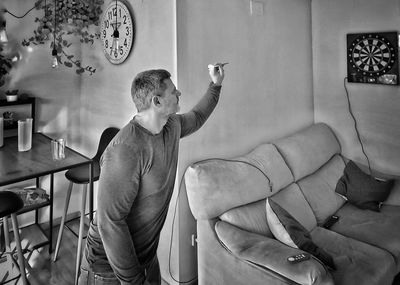 Portrait of young man sitting on chair