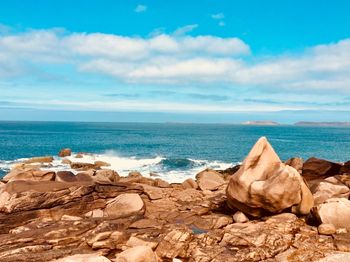 Rocks on beach against sky