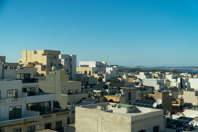 High angle view of townscape against clear blue sky