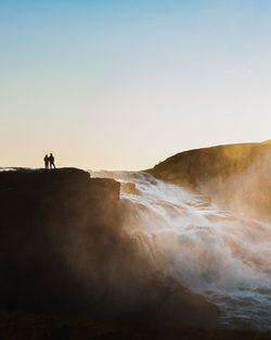 Scenic view of sea against clear sky waterfall