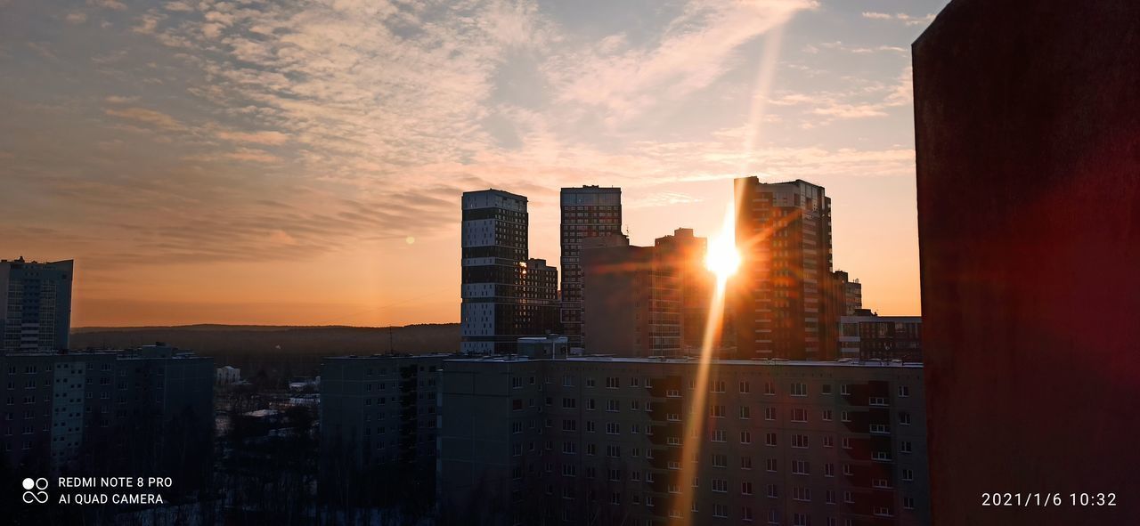 MODERN BUILDINGS IN CITY DURING SUNSET