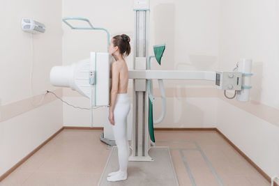 Side view of woman having mammography scanning