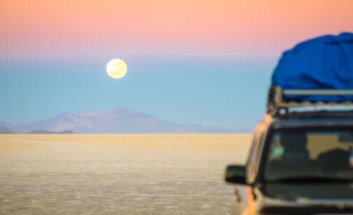 Scenic view of desert against sky at sunset