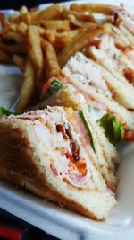 Close-up of fresh lobster sandwich and french fries served on table