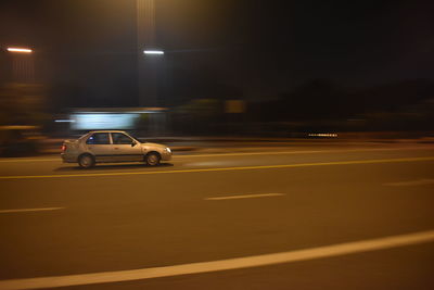 Cars moving on illuminated road at night