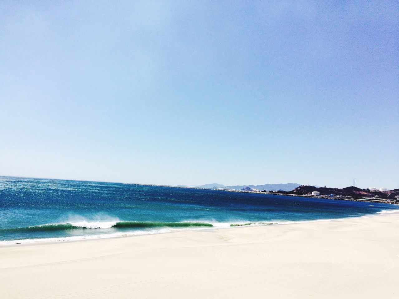 sea, beach, clear sky, water, copy space, shore, horizon over water, blue, scenics, sand, tranquil scene, beauty in nature, tranquility, wave, surf, coastline, nature, idyllic, incidental people, day