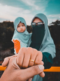 Rear view of couple holding hands