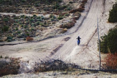 Man riding motorcycle on dirt road