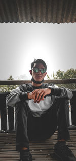 Portrait of young man sitting on seat