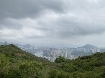 View of city buildings against cloudy sky