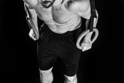 Low angle view of man standing against black background