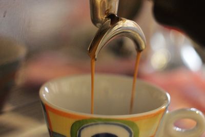 Close-up of coffee pouring in glass